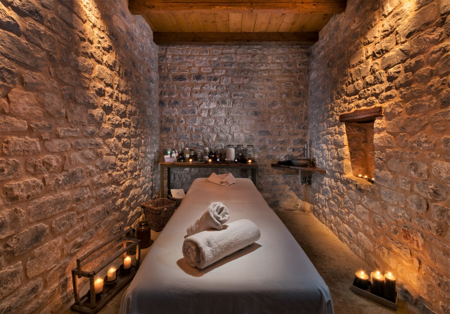 Candlelit stone-vaulted treatment room at Ioni Spa, Petra & Fos
