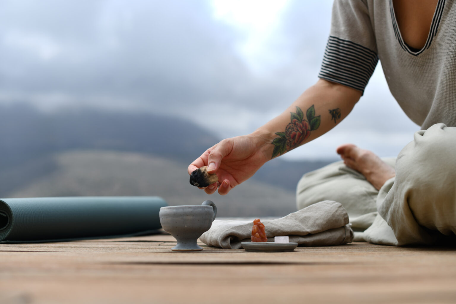 Wellness ritual with tea on a terrace overlooking the Mani coastline